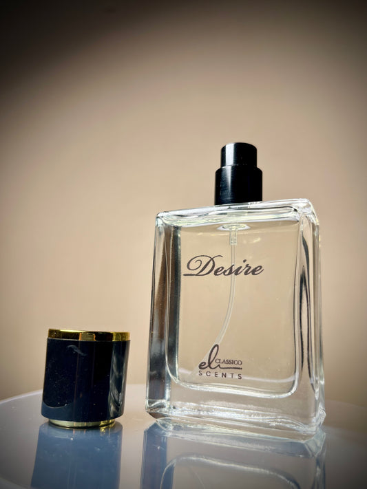 Perfume bottle labeled 'Desire' by el clasicco scents on a reflective surface with a neutral background