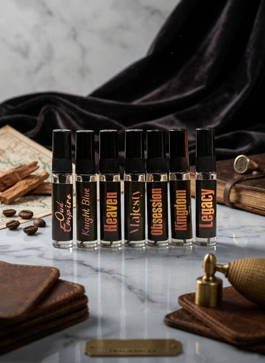 Set of small bottles with labels on a marble surface with a dark fabric background.