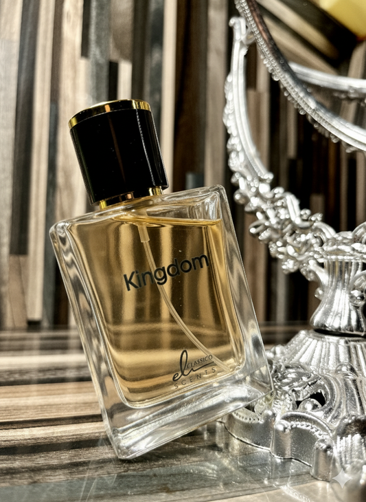 Perfume bottle labeled 'Kingdom' on a reflective surface with a decorative mirror in the background